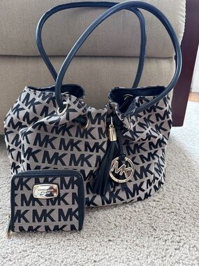 Michael Kors Black and Beige MK Logo Drawstring Tote with Tassel Charm